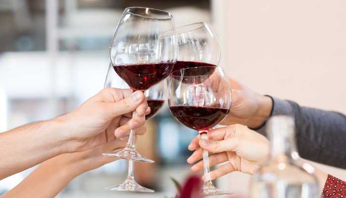 people holding wine glasses toast