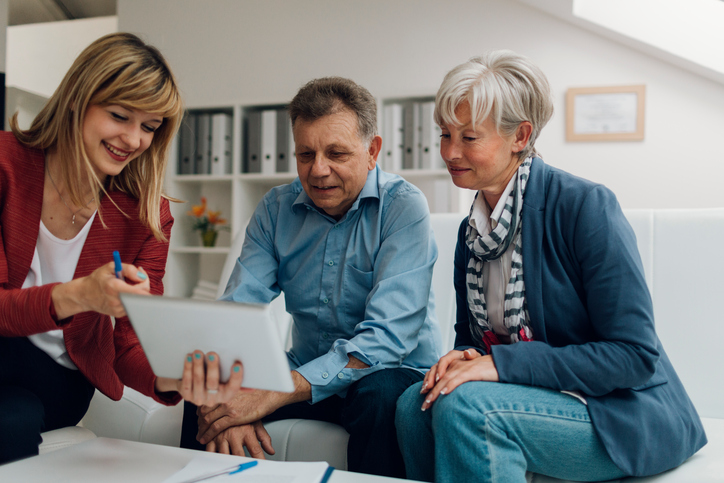 an old couple going through franchising plans with a franchise broker