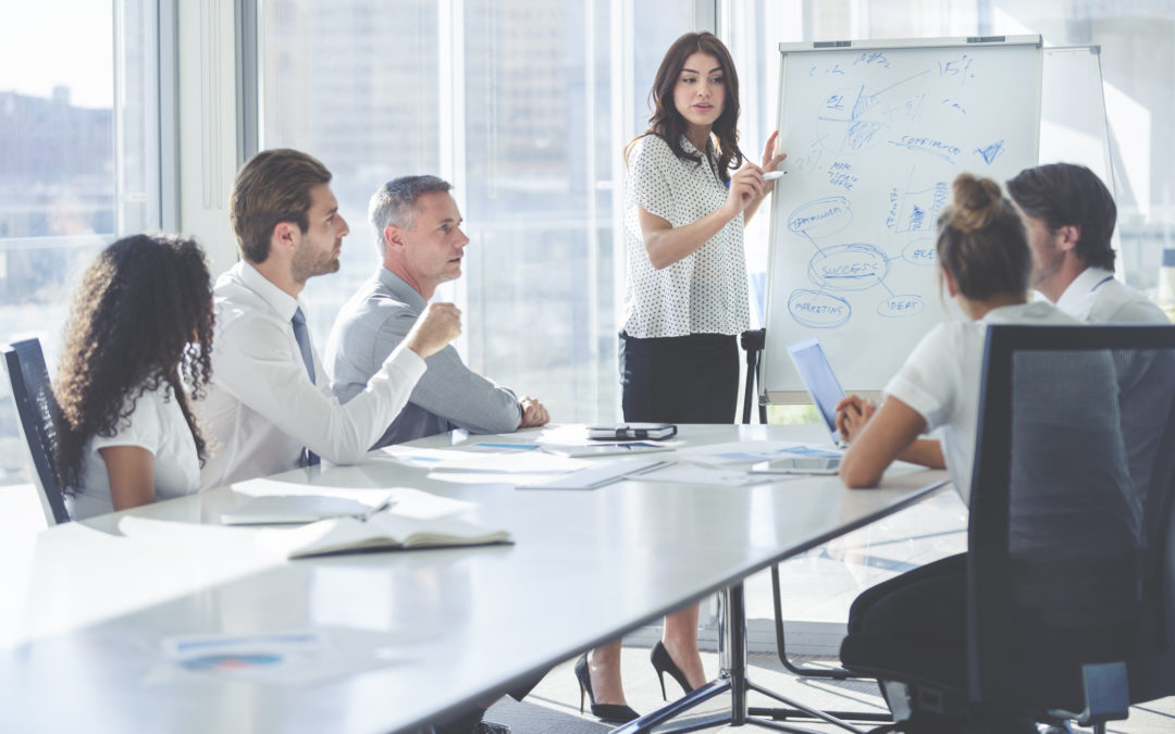 businesswoman giving a presentation to her team