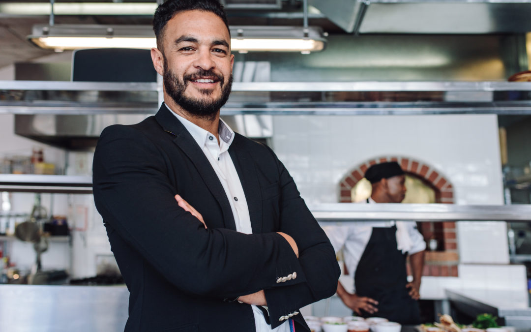 a businessman standing in his restaurant