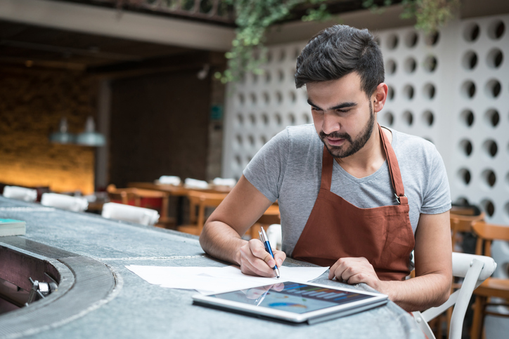 a business owner looking at his business statistics