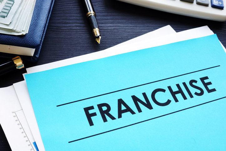 Documents with title franchise on a desk
