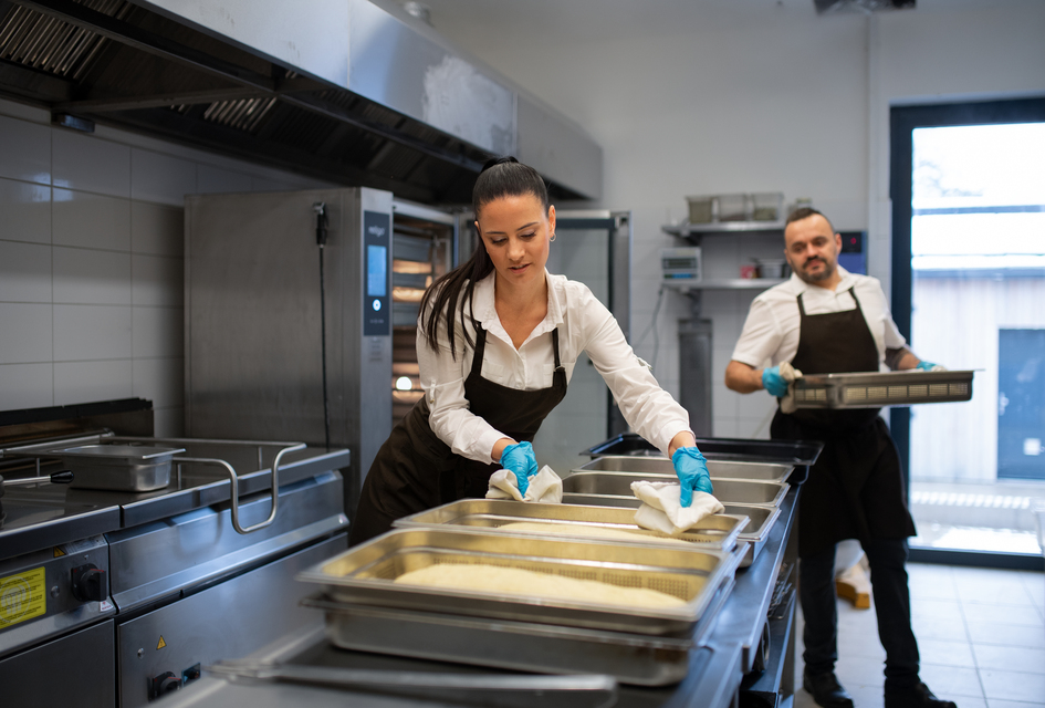 Chef preparing meals in a professional kitchen, representing the culinary expertise behind a thriving restaurant franchise.