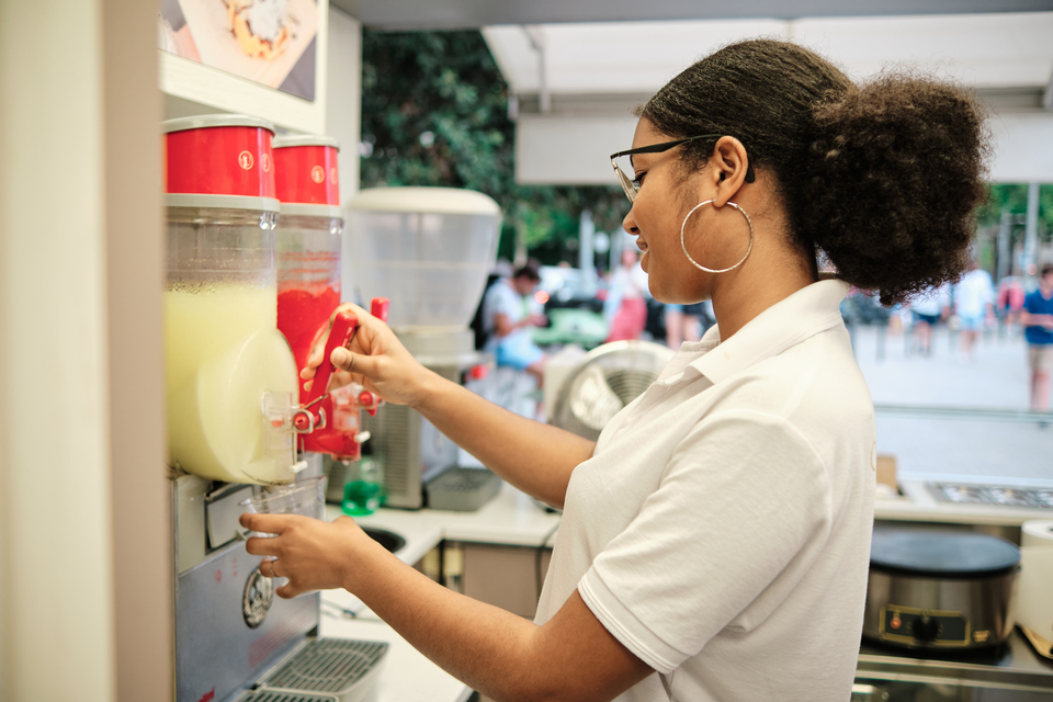 Franchise operator managing a branded soda dispensing station, showcasing a self-serve beverage concept ready for franchise expansion.
