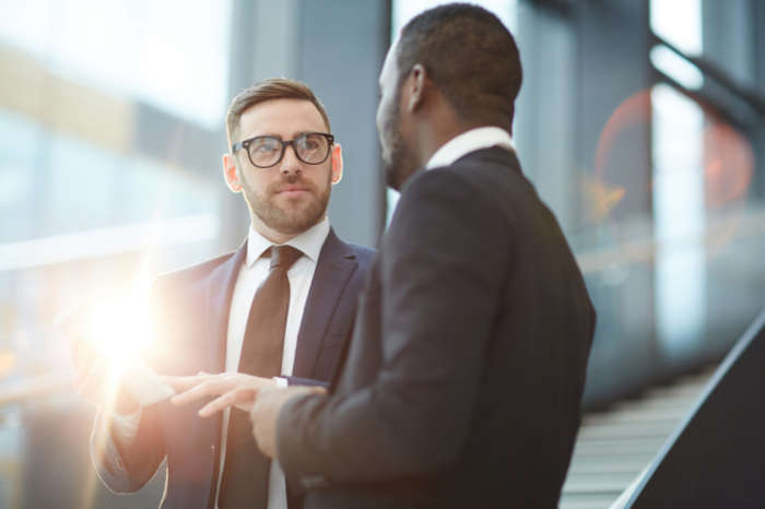 two businessmen talking with each other